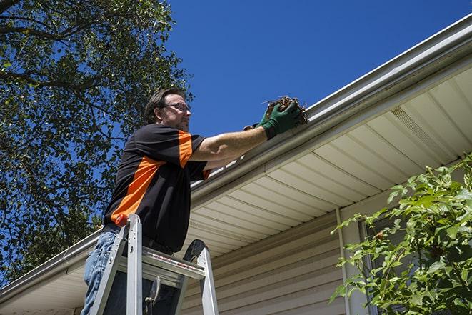 a worker conducting maintenance on a gutter in West Sacramento, CA